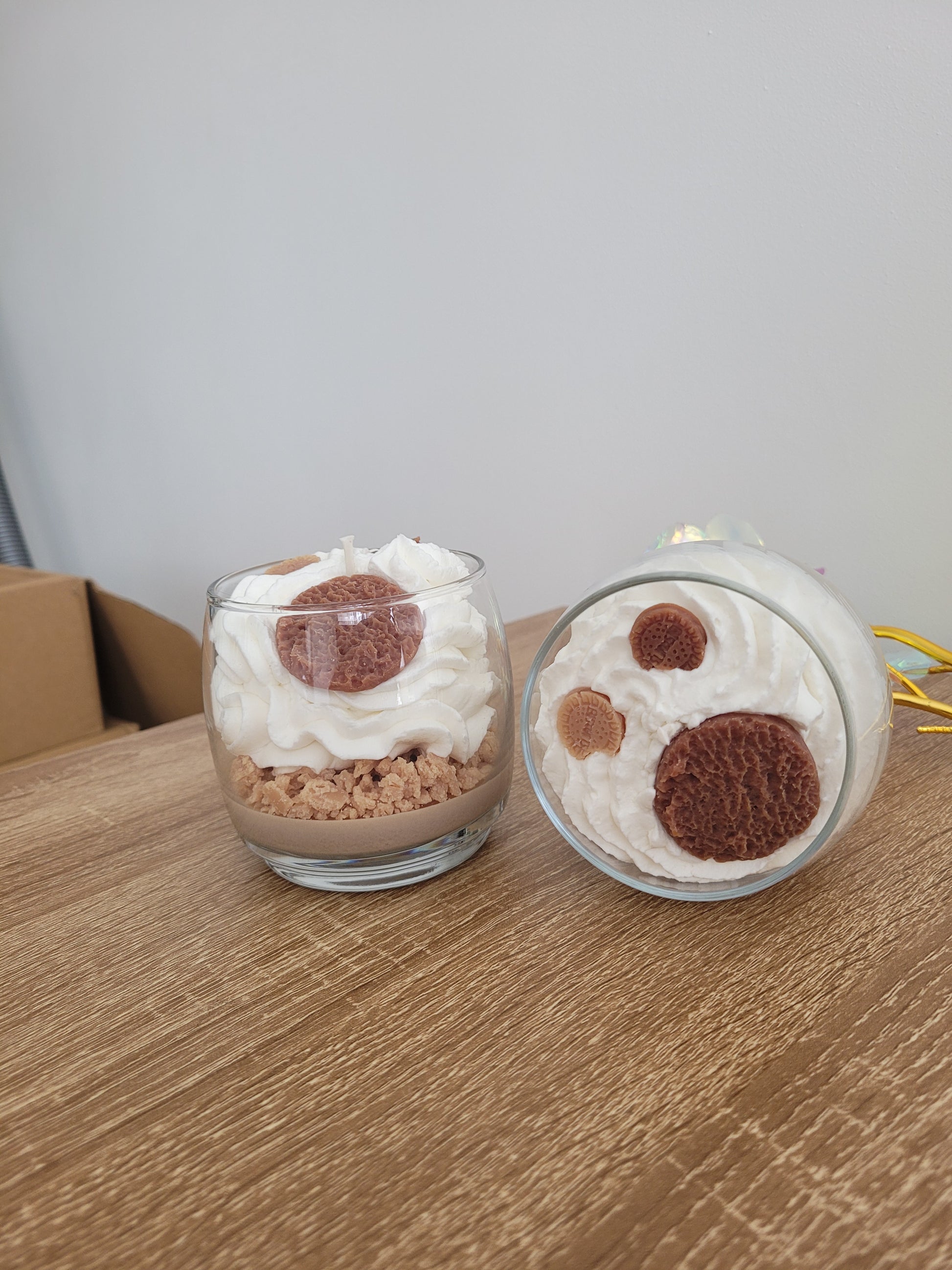  Vue du dessus d’une bougie parfum Éclats de Cookies, chantilly blanche ornée de crumble marron et petits cookies décoratifs, mettant en valeur les détails gourmands et faits main.
